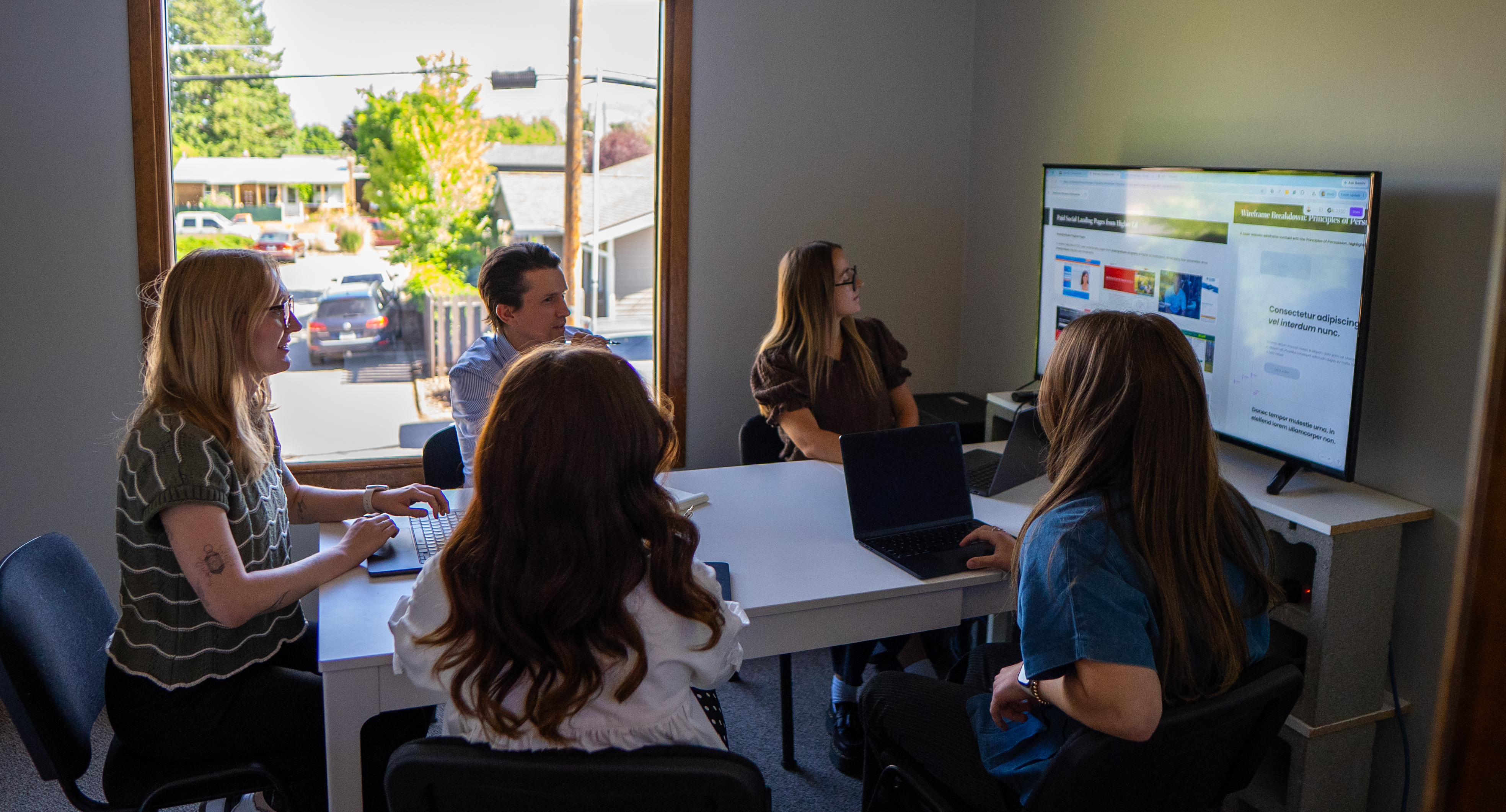 The Pintler Group team crowds around a screen, eyes locked on live dashboards as UM‑alum strategists, developers and creatives trade rapid‑fire ideas about how to turn more clicks into real, measurable leads.