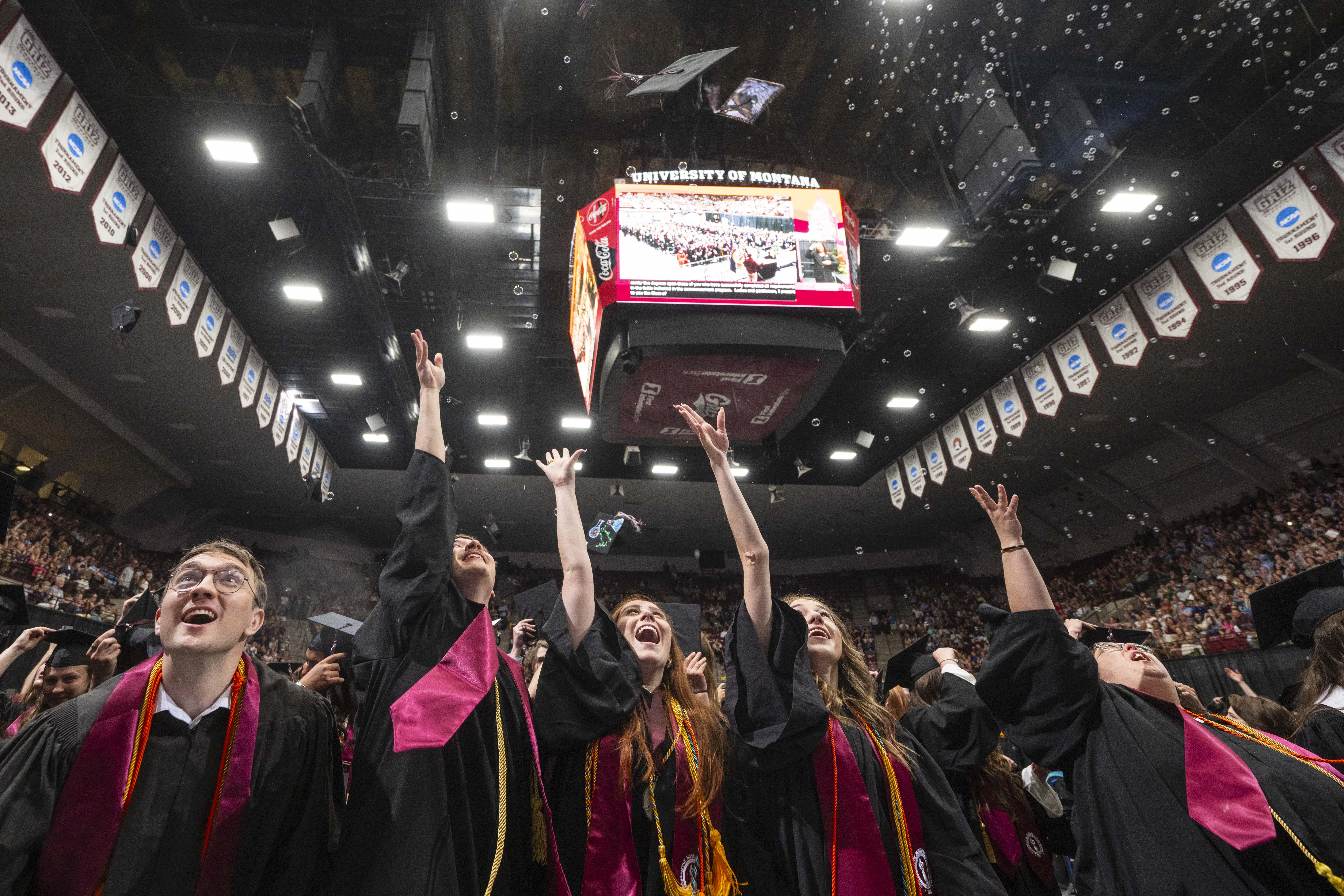Images of graduates throwing caps.