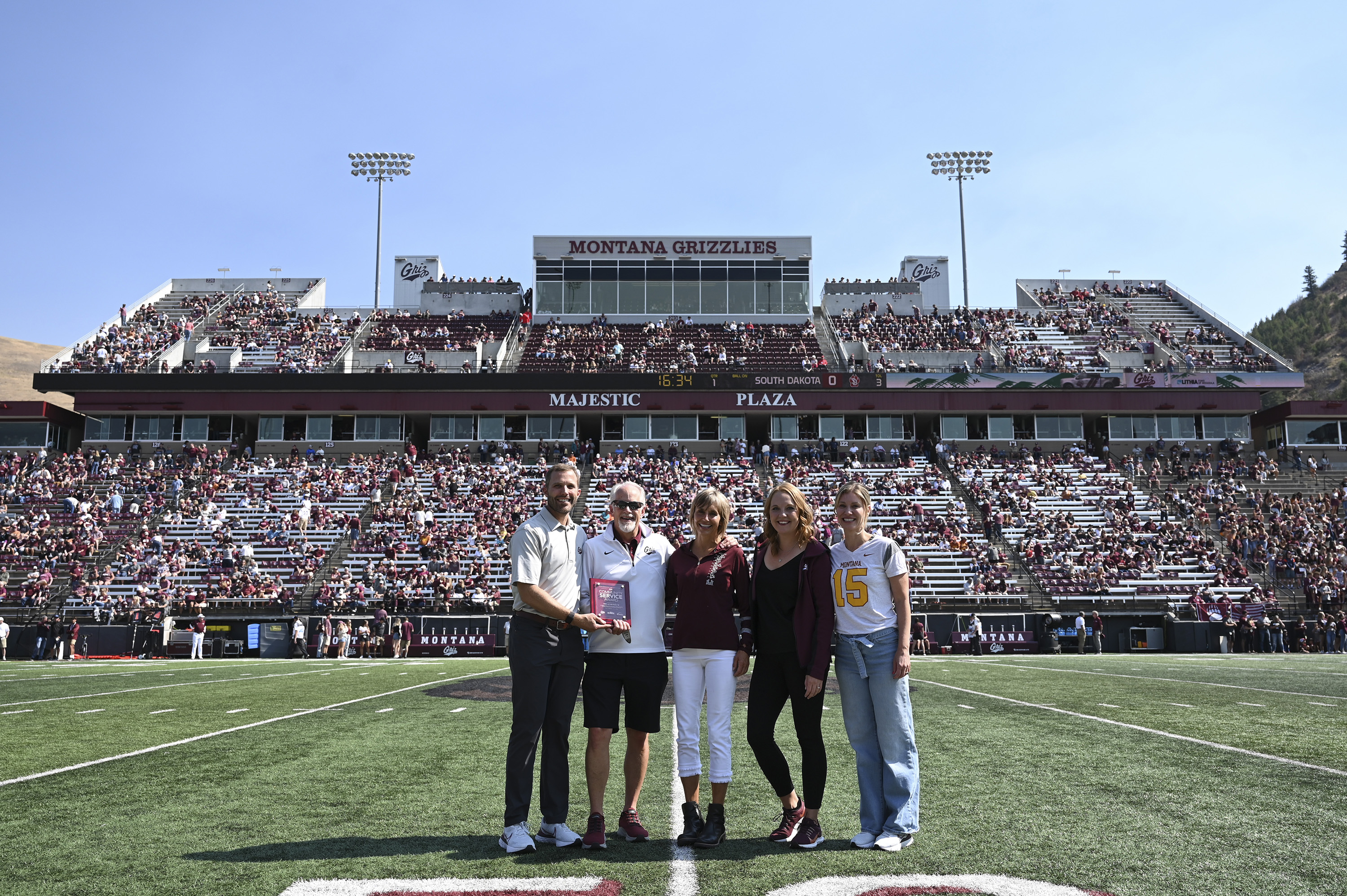 John and Stella Burke on field with University dignitaries