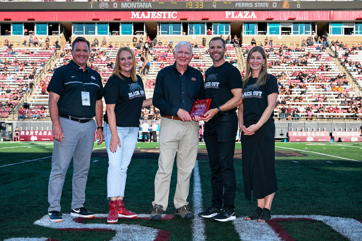 Bill Beecher on field with University dignitaries