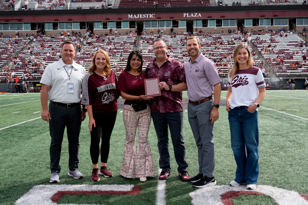 Dirk and Carmen Cappis on field with University dignitaries